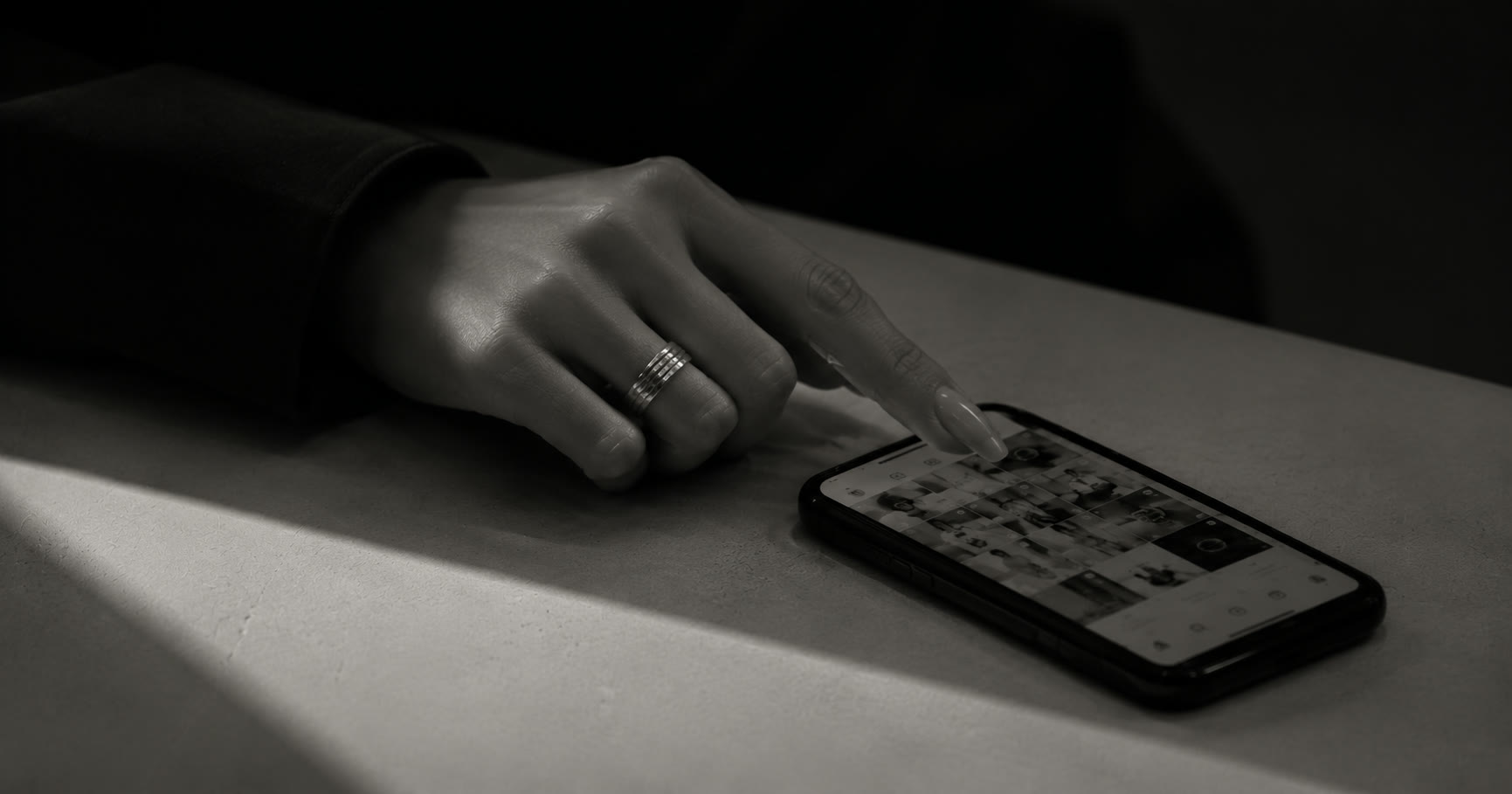 A hand scrolling a curated Instagram grid on a phone