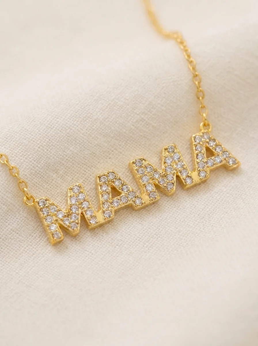 MAMA crystal necklace close-up on cream