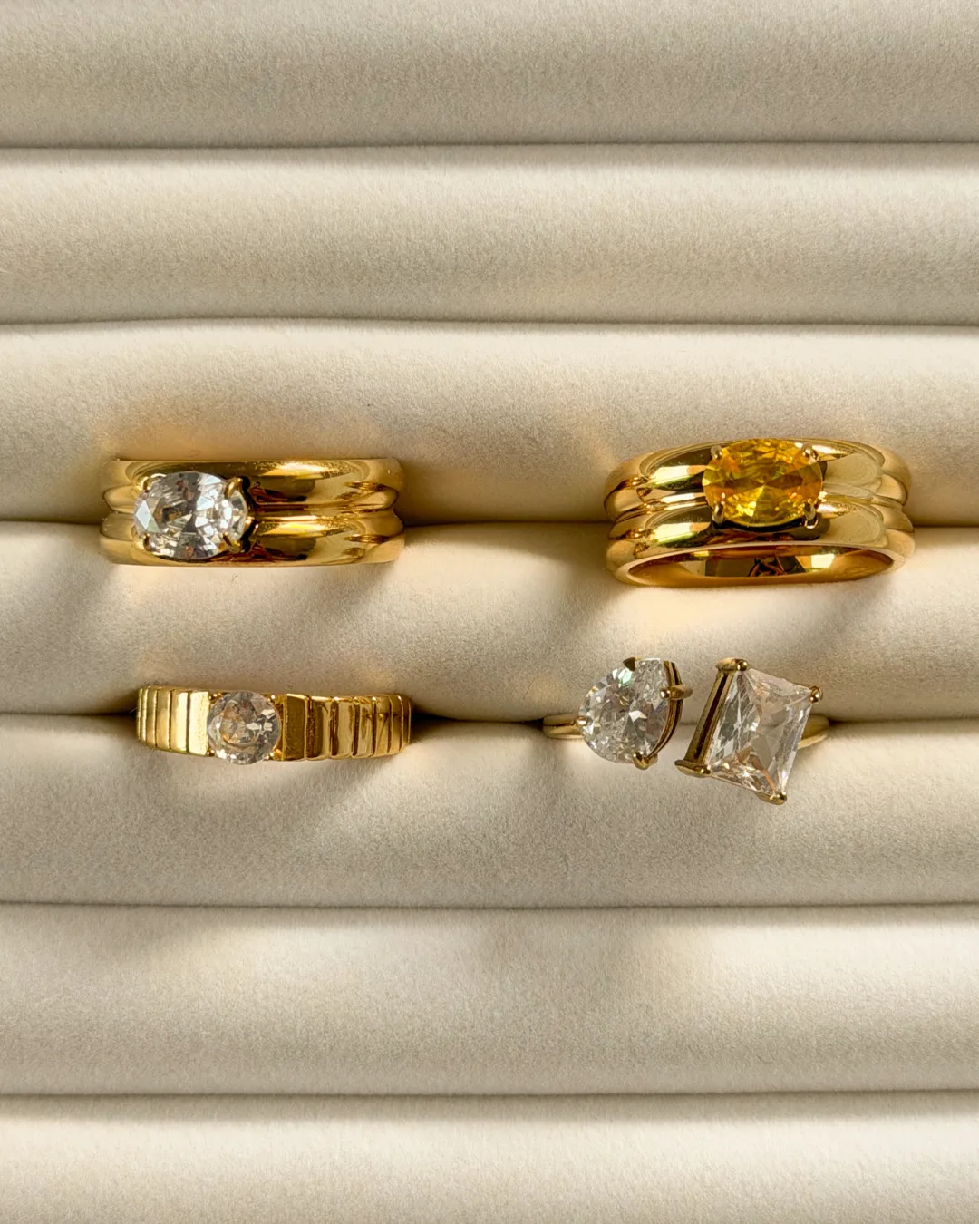 Gold rings styled on rolled cream fabric