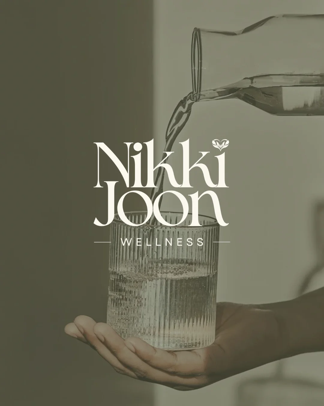 The wordmark over a glass of water being poured